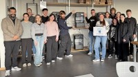 Lehrkräfte und Schülerinnen und Schüler der Louis-Lepox-Schule vor einem 3-D-Drucker