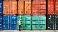 Ein Schifffahrtskaufmann sucht seinen Container mit zu verschiffenden Waren.