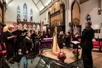 Ein Kirchenmusiker leitet einen Chor in einer Kirche an.