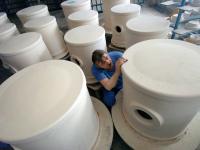 Ein Industriekeramiker Anlagentechnik prüft Mahlgefäße aus Porzellan für Trommelmühlen.